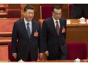 Chinese President Xi Jinping and Chinese Premier Li Keqiang arrive for the closing session of the National People's Congress in Beijing's Great hall of the People on Friday, March 15, 2019.