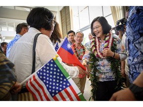 In this Wednesday, March 27, 2019, photo released by the Taiwan Presidential Office, Taiwanese President Tsai Ing-wen, right, is greeted by supporters upon arriving in Hawaii. Speaking during the visit to Hawaii on Wednesday, Tsai said requests have been submitted to the U.S. for F-16V fighters and M1 Abrams tanks. If approved, the move could set off new tensions between the U.S. and China, which considers Taiwan its own territory to be annexed by force if necessary. (Taiwan Presidential Office via AP)