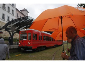 Staff members walk near a train in the Huawei's Ox Horn campus in Songshan Lake in Dongguan, China's Guangdong province, Wednesday, March 6, 2019. Huawei Technologies Co. is one of the world's biggest supplier of telecommunications equipment.