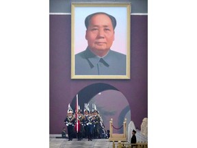 A Chinese honor guard marches out beneath the large portrait of Chinese leader Mao Zedong to perform the daily flag raising ceremony at Tiananmen Square on the eve of the opening session of China's National People's Congress (NPC) in Beijing, Tuesday, March 5, 2019. A year since removing any legal barrier to remaining China's leader for life, Xi Jinping appears firmly in charge, despite a slowing economy, an ongoing trade war with the U.S. and rumbles of discontent over his concentration of power.