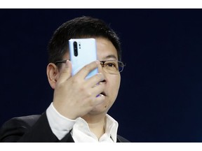 Huawei CEO Richard Yu displays the new Huawei P30 smartphone during a presentation, in Paris, Tuesday, March 26, 2019.