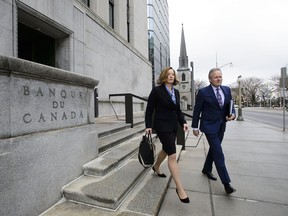 Stephen Poloz, Governor of the Bank of Canada and Senior Deputy Governor Carolyn Wilkins make their way to hold a press conference at the National Press Theatre, in Ottawa on Wednesday, April 24, 2019.