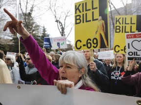 Pro-pipline supporters rally outside a public hearing of the Senate Committee on Energy, the Environment and Natural Resources regarding Bill C-69 in Calgary.