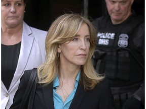 FILE - In this April 3, 2019 file photo, actress Felicity Huffman arrives at federal court in Boston to face charges in a nationwide college admissions bribery scandal. In a court filing on Monday, April 8, 2019, Huffman agreed to plead guilty in the cheating scam.