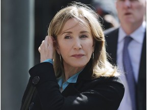 FILE - In this April 3, 2019 file photo, actress Felicity Huffman arrives at federal court in Boston to face charges in a nationwide college admissions bribery scandal. Huffman will plead guilty on May 13 to charges that she took part in the cheating scam. She had been scheduled to enter her plea on May 21, but a judge agreed to move up the hearing because the lead prosecutor will be out of town.