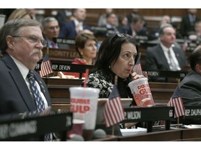 FILE - In this Feb. 20, 2019 file photo, state Rep. Anne Dauphinais R-Killingly, takes a sip from a big gulp soda as Connecticut Democrat Gov. Ned Lamont delivers his budget address at the State Capitol in Hartford, Conn. Lamont proposed a tax on sugary drinks in his first budget. Connecticut is among several states likely to see debate this year over taxes that advocates endorse as way to reduce consumption of liquid calories. On March 25 the American Academy of Pediatrics and the American Heart Association called for education campaigns and raising prices through taxes to reduce consumption of sugary drinks by young people.