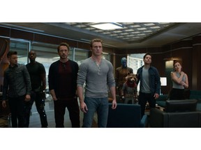 This image released by Disney shows, from left, Jeremy Renner, Don Cheadle, Robert Downey Jr., Chris Evans, Karen Gillan, the character Rocket, voiced by Bradley Cooper, Paul Rudd and Scarlett Johansson in a scene from "Avengers: Endgame." (Disney/Marvel Studios via AP)