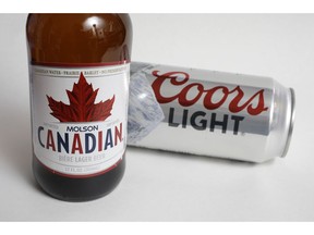 In this Feb. 14, 2018, file photo, Molson Coors products Molson Canadian beer, left, and Coors Light beer are shown in Walpole, Mass. A group of alcohol and cannabis companies have formed an industry alliance to push for changes to proposed rules governing pot-infused beverages before edibles become legal in the coming months.