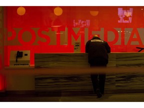 A security guard stands by the front reception desk at Postmedia's Toronto headquarters on Monday, March 12, 2018. Postmedia Network Canada Corp. says it lost nearly $5.1 million in the second quarter as its revenue dropped 7.5 per cent compared with last year as a result of shifting advertising and circulation patterns.THE CANADIAN PRESS/Chris Young