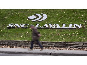 A man walks past the headquarters of SNC-Lavalin in Montreal on November 6, 2014.