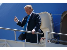 President Donald Trump gives a thumbs up as he arrives at San Antonio International Airport for fundraising events, Wednesday, April 10, 2019, in San Antonio.