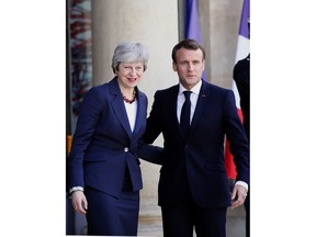 French President Emmanuel Macron, right, and British Prime Minister Theresa May pose before a meeting at the Elysee Palace in Paris Tuesday, April 9, 2019. A top official at the French presidency says France doesn't rule out granting a further delay to Brexit, just before a planned meeting between Prime minister Theresa May and President Emmanuel Macron in Paris.