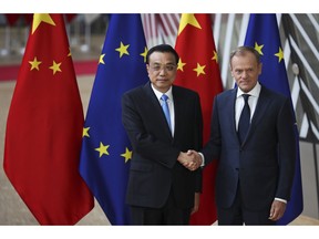 China's Premier Li Keqiang, left, shakes hands with European Council President Donald Tusk during an EU-China summit at the European Council headquarters in Brussels, Tuesday, April 9, 2019.