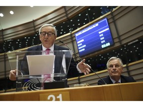 European Commission President Jean-Claude Juncker, left, addresses European Parliament members next to European Union chief Brexit negotiator Michel Barnier at the European Parliament in Brussels, Wednesday, April 3, 2019. With Britain racing toward a chaotic exit from the European Union within days, Prime Minister Theresa May veered away from the cliff-edge Tuesday, saying she would seek another Brexit delay and hold talks with the opposition to seek a compromise.