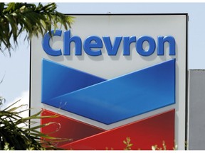 FILE- This Aug. 20, 2012, file photo, shows a Chevron sign in Miami. A Northern California jury ordered Chevron Corp. to pay the families of two brothers a combined $21.4 million after they claimed the men's exposure to a toxic chemical while working at a company plant caused the cancer that killed them. The San Francisco Chronicle reported that The Contra Costa County jury's verdict Friday, March 29, 2019. Brothers Gary Eaves and Randy Eaves worked at a Chevron-owned tire manufacturer in Arkansas.