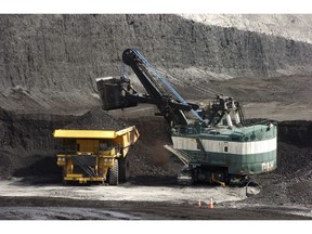 FILE - In this April 4, 2013, file photo, a mechanized shovel loads a haul truck with coal at the Spring Creek coal mine near Decker, Mont. A federal judge in Montana says the Trump administration failed to consider the environmental effects of resuming coal sales from federal lands, but stopped short of halting future sales. U.S. District Judge Brian Morris on Friday, April 19, 2019, ordered government attorneys to enter negotiations with states and environmental groups that had sued to stop the lease sales.