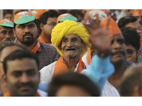 An elderly supporter of ruling Bharatiya Janata Party (BJP) smiles a he attends an election campaign rally addressed by Indian Prime Minister Narendra Modi in Hyderabad, India, Monday, April 1, 2019. India's general elections will be held in seven phases starting April 11.