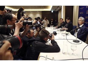 Junichiro Hironaka, lawyer of former Nissan chairman Carlos Ghosn, right, attends a press conference in Tokyo, Tuesday, April 2, 2019. Hironaka said his client cannot get a fair trial under the same judge as the Japanese automaker, which is a co-defendant in a pending financial misconduct case, arguing Nissan has been acting "as one" with the prosecutors.(