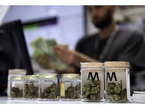 FILE - In this July 1, 2017, file photo, a cashier rings up a marijuana sale at the Essence cannabis dispensary in Las Vegas. Complaints that the state releases no information about who applies for and receives dispensary licenses in Nevada's booming retail marijuana business are spurring lawsuits and legislative proposals that appear poised to push the process public.