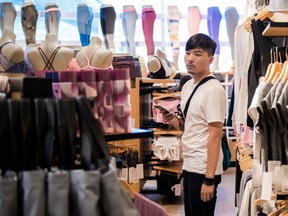 A customer looks at athletic apparel inside a Lululemon Athletica Inc. store at the International Finance Centre mall in Hong Kong, China.