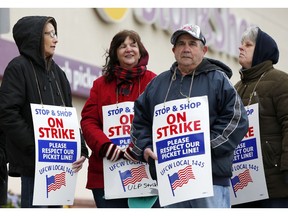 Striking workers stand on a picket line outside the Stop & Shop supermarket in Revere, Mass., Thursday, April 18, 2019. Some Jewish families in southern New England are preparing for Passover without the region's largest supermarket chain. Thousands of workers remain on strike and rabbis in Massachusetts, Connecticut and Rhode Island are advising their congregations not to cross the picket lines.