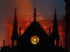 lames and smoke rise from Notre Dame cathedral as it burns in Paris, Monday, April 15, 2019.