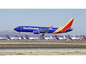 FILE - In this March 23, 2019 file photo a Southwest Airlines Boeing 737 Max aircraft lands at the Southern California Logistics Airport in the high desert town of Victorville, Calif.  Southwest is removing flights with the troubled Boeing 737 Max aircraft from its schedule through Aug. 5, a period that includes the peak of the airline's busy summer travel season. The company did not specify how many flights would be cancelled because of the new schedule.