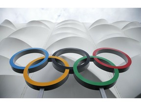 FILE - This July 15, 2012 file photo shows the Olympic rings displayed outside the basketball arena in the Olympic Park before the start of the 2012 Summer Olympics in London.  NBC Universal and the LA Olympics are going into business together, combining to package commercial time on all the network's platforms with opportunities to sponsor the American team through 2028. The deal is for contracts covering 2021 through 2028, the year the Summer Games return to the United States for the first time in 32 years.