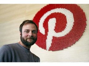 FILE - In this Oct. 11, 2018, file photo, Evan Sharp, Pinterest co-founder and chief product officer, poses for a photo beside a wall of pegs symbolizing the company logo at Pinterest headquarters in San Francisco. Pinterest plans to raise up to approximately $1.47 billion in its initial public offering. The Digital scrapbooking site said in a Monday, April 8, 2019, regulatory filing that the offering includes about 86.3 million shares, priced between $15 and $17 per share. Pinterest is offering 75 million Class A shares.