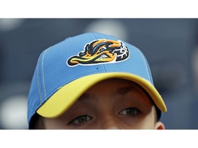 Jake Sheehan, 9, wears an Akron RubberDucks cap as he watches a minor league baseball game between Akron and the Bowie Baysox, Thursday, April 18, 2019, in Akron, Ohio. For Akron, whose history is intertwined with the rubber industry's, "a tough, gritty duck that's really got that blue-collar ethos to it" was an ideal choice to rebrand, for both adults and kids.