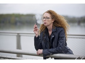Chantel Williams vapes from a Juul pen in Vancouver, Wash., Tuesday, April 16, 2019. She tried gums, patches and various electronic cigarettes to quit smoking. What finally worked for Williams was the small, reusable e-cigarette that has a strong nicotine punch.