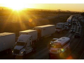 A row of trucks wait to cross the border with the United States in Ciudad Juarez, Mexico, Tuesday, April 9, 2019. The Trump administration has reassigned so many inspectors from U.S.-Mexico border crossings that it has caused huge traffic backups for truckers who are waiting in line for hours and in some case days to get shipments to the U.S.