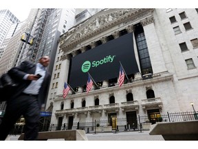 FILE - In this April 3, 2018 file photo, a Spotify banner adorns the facade of the New York Stock Exchange. Spotify reports financial results on Monday, April 29, 2019.