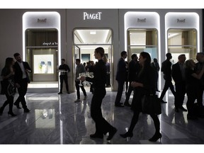 FILE- In this March 14, 2019, file photo people attend the opening of a Piaget store during the opening night of The Shops & Restaurants at Hudson Yards in New York. On Monday, April 1, the Commerce Department releases U.S. retail sales data for February.
