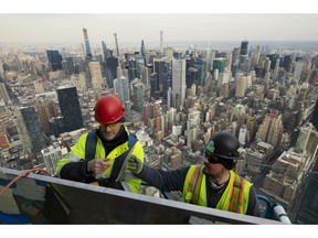 FILE- In this March 8, 2019, file photo, work continues on an outdoor observation deck on the 30 Hudson Yards office building in New York. On Monday, April 1, the Commerce Department reports on U.S. construction spending in February.