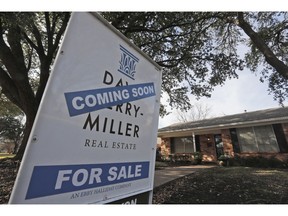 FILE- In this Feb. 20, 2019, file photo a coming soon for sale sign sits in front of a home in the Dallas suburb of Richardson, Texas. On Monday, April 22, the National Association of Realtors reports on sales of existing homes in March.
