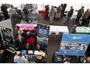 FILE- In this March 7, 2019, file photo visitors to the Pittsburgh veterans job fair meet with recruiters at Heinz Field in Pittsburgh. On Tuesday, April 10, the Labor Department reports on job openings and labor turnover for February.
