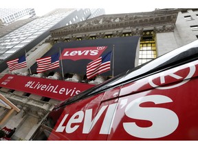 FILE- In this March 21, 2019, file photo a Levi's banner adorns the facade of the New York Stock Exchange. Levi Strauss & Co. reports financial results on Tuesday, April 9.
