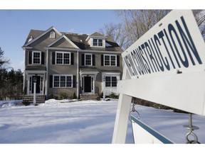 FILE - In this Feb. 21, 2019, file photo a sign is posted near a newly constructed home in Natick, Mass. On Tuesday, April 23, the Commerce Department reports on sales of new homes in March.