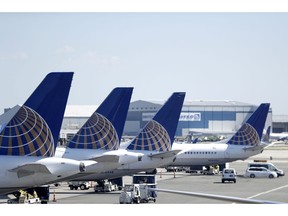 FILE - In this  July 18, 2018, file photo, United Airlines commercial jets sit at a gate at Terminal C of Newark Liberty International Airport in Newark, N.J. The grounding of its Boeing 737 Max jets is causing United Airlines to trim growth plans for this year, and the carrier expects to discuss potential compensation with Boeing.