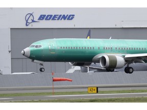 FILE - In this April 10, 2019, file photo a Boeing 737 MAX 8 airplane being built for India-based Jet Airways lands following a test flight at Boeing Field in Seattle. Boeing Co. reports earnings Wednesday, April 24.