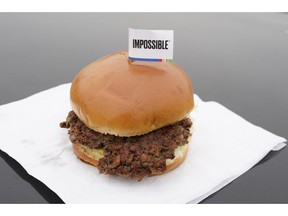 FILE- This Jan. 11, 2019, file photo shows the Impossible Burger, a plant-based burger containing wheat protein, coconut oil and potato protein among it's ingredients in Bellevue, Neb. From soy-based sliders to ground lentil sausages, plant-based meat substitutes are surging in popularity. Growing demand for healthier, more sustainable food is one reason people are seeking plant-based meats.