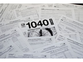 This Feb. 13, 2019, photo shows multiple forms printed from the Internal Revenue Service web page that are used for 2018 U.S. federal tax returns in Zelienople, Pa. The head of the IRS, overseeing the most sweeping overhaul of the U.S. tax codes in three decades, says the average refund in this year's tax-filing season, $2,833, worked out to be close to last year's. Internal Revenue Service Commissioner Charles Rettig told Congress Wednesday that an increase is urgently needed in the agency's budget to modernize antiquated computer systems and protect taxpayers' data.