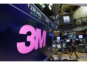 FILE- In this Oct. 24, 2017, file photo, the logo for 3M appears on a screen above the trading floor of the New York Stock Exchange. 3M plans to cut 2,000 globally as part of a restructuring due to a slower-than-expected 2019. The maker of Post-it notes, industrial coatings and ceramics said Thursday that the move is expected to save about $225 million to $250 million a year.