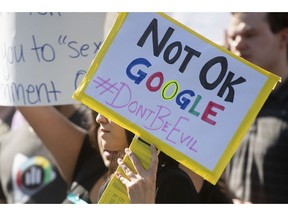 FILE - In this Nov. 1, 2018, file photo, workers protest against Google's handling of sexual misconduct allegations at the company's Mountain View, Calif., headquarters. Google says it has updated the way it investigates misconduct claims, changes it pledged to make after thousands of employees walked out in protest last November. The company says the changes make it simpler for employees to file complaints about sexual misconduct or other harassment. The move follows claims by two walkout organizers that they faced Google retaliation for helping to put together the protest.