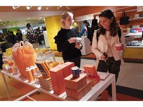 FILE - In this April 10, 2019, file photo visitors to Story walk through the shop now located at Macy's in New York. On Thursday, April 18, the Commerce Department releases U.S. retail sales data for March.