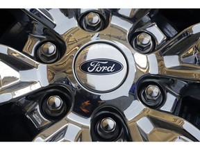FILE- In this Feb. 14, 2019, file photo a wheel on a 2019 Ford Expedition 4x4 is displayed at the 2019 Pittsburgh International Auto Show in Pittsburgh. Ford Motor Co. reports earns on Thursday, April 25.