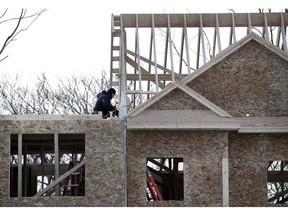 In this Jan. 23, 2019, photo, construction workers build new housing in Salisbury, Mass. On Friday, April 19, the Commerce Department reports on U.S. home construction in March.