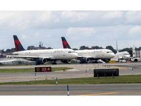 FILE - In this Aug. 8, 2017 file photo, Delta Air Lines airplanes line the tarmac ahead of a groundbreaking ceremony of the construction on Delta Air Lines $4 billion, 37-gate facility at LaGuardia Airport, in the Queens borough of New York. A technical outage is impacting major airlines and causing flight delays that may lead to a ripple effect throughout the day. The Federal Aviation Administration said Monday, April 1 that several airlines were dealing with computer issues. The agency recommended people contact their airline directly for flight information and updates. There are some delays already at airports in Chicago, New York, Boston, Atlanta, Miami and Detroit. Delta said some of its flights were impacted.