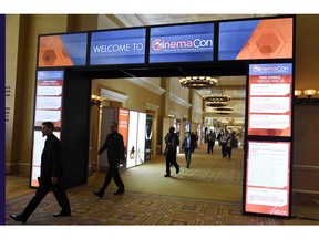 FILE - This April 26, 2018, file photo shows CinemaCon attendees walking through the lobby during CinemaCon 2018 in Las Vegas, the official convention of the National Association of Theatre Owners. The movie industry, everyone from the Hollywood studios that produce the films to the companies that make the screens, speakers and seats in theaters, are descending on Las Vegas this week for CinemaCon.